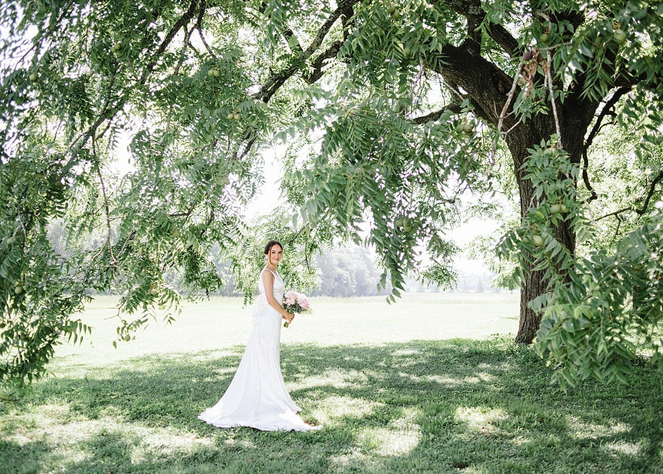 Bride posing under pecan tree in Aiken, South Carolina