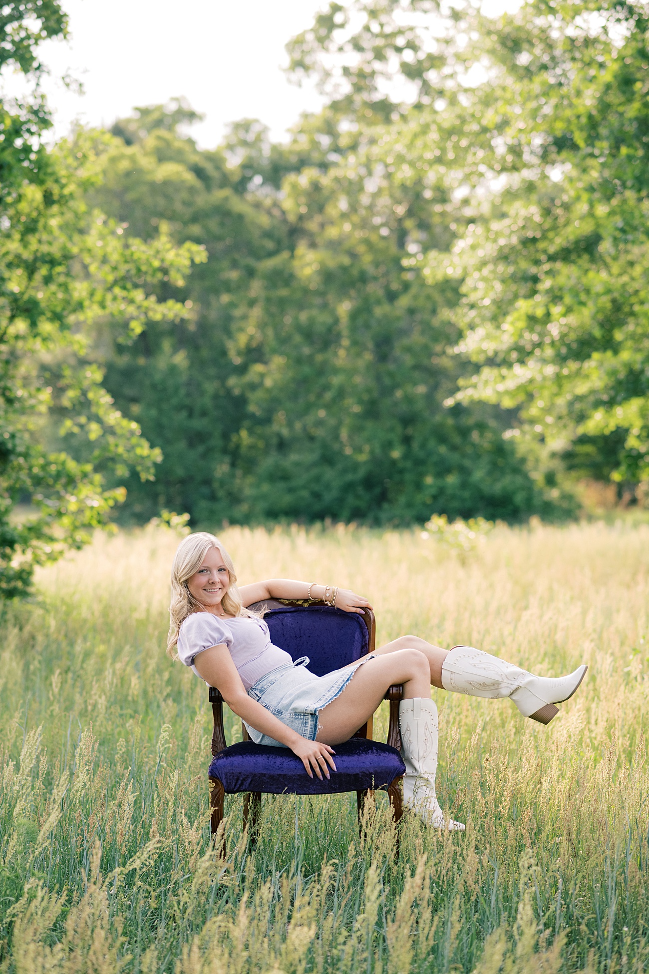 Bright and colorful outdoor senior portraits with vintage purple chair