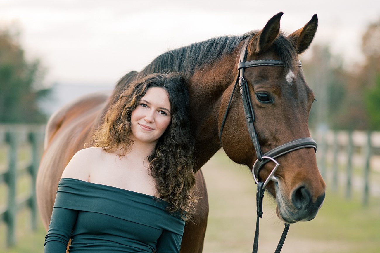 Beautiful high school senior with elegant bay horse