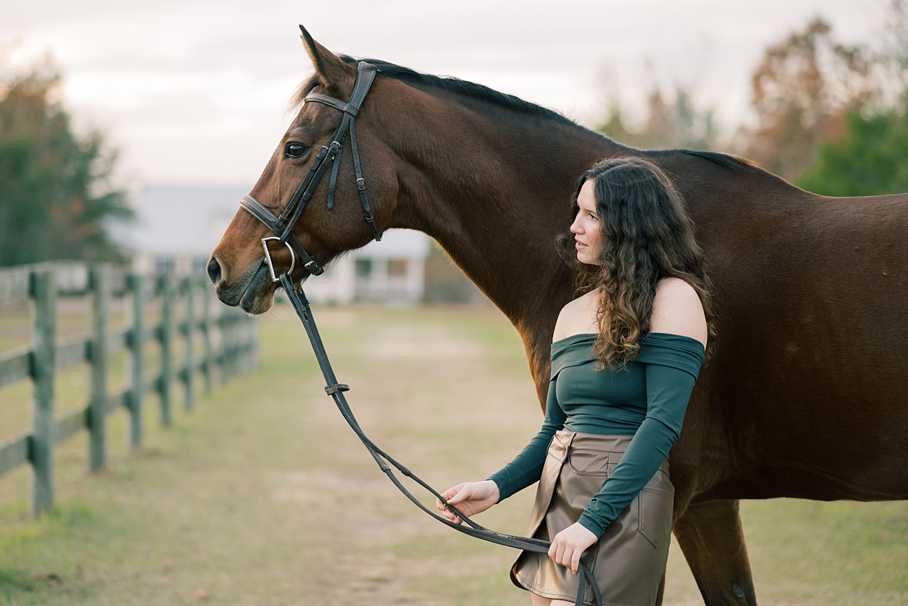 Beautiful high school senior with elegant bay horse